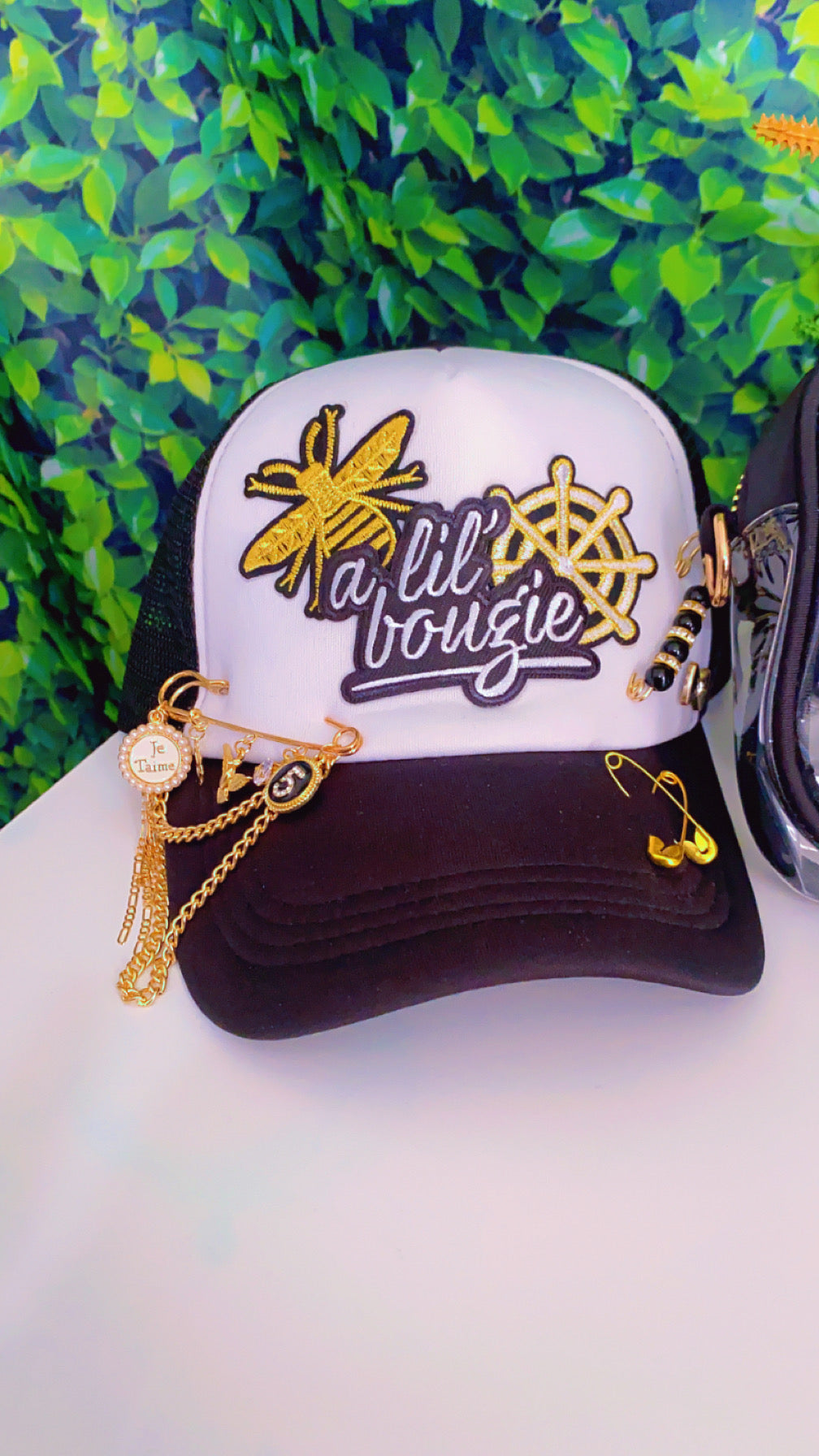 A Bouji trucker hat and purse set (strap for purse included)